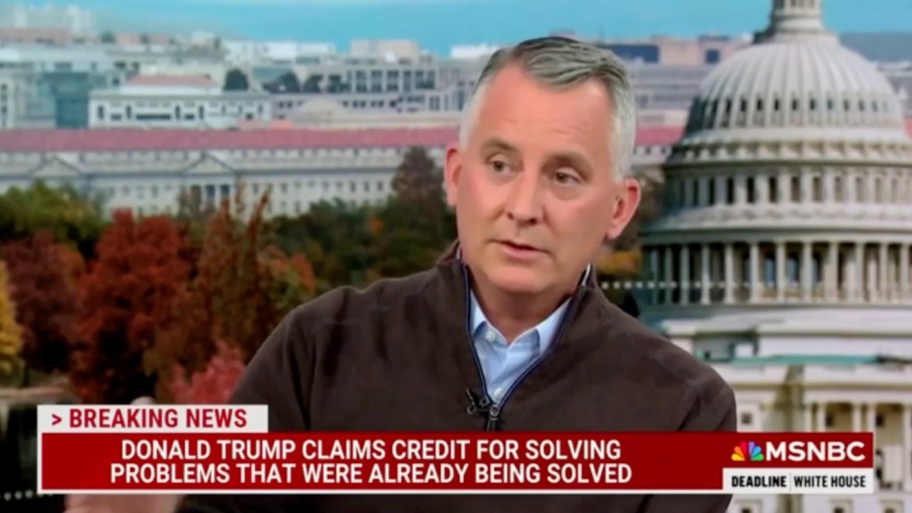 Former lawmaker and MSNBC analyst David Jolly speaking critically in front of a building